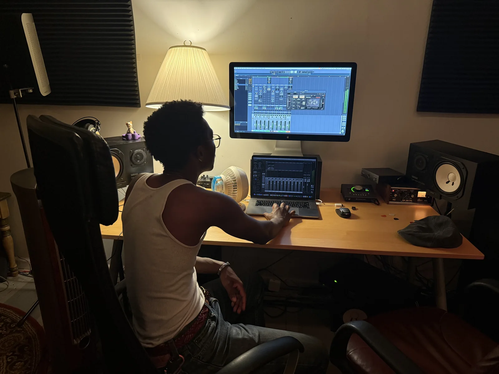 Apostle working at a desk in a music studio