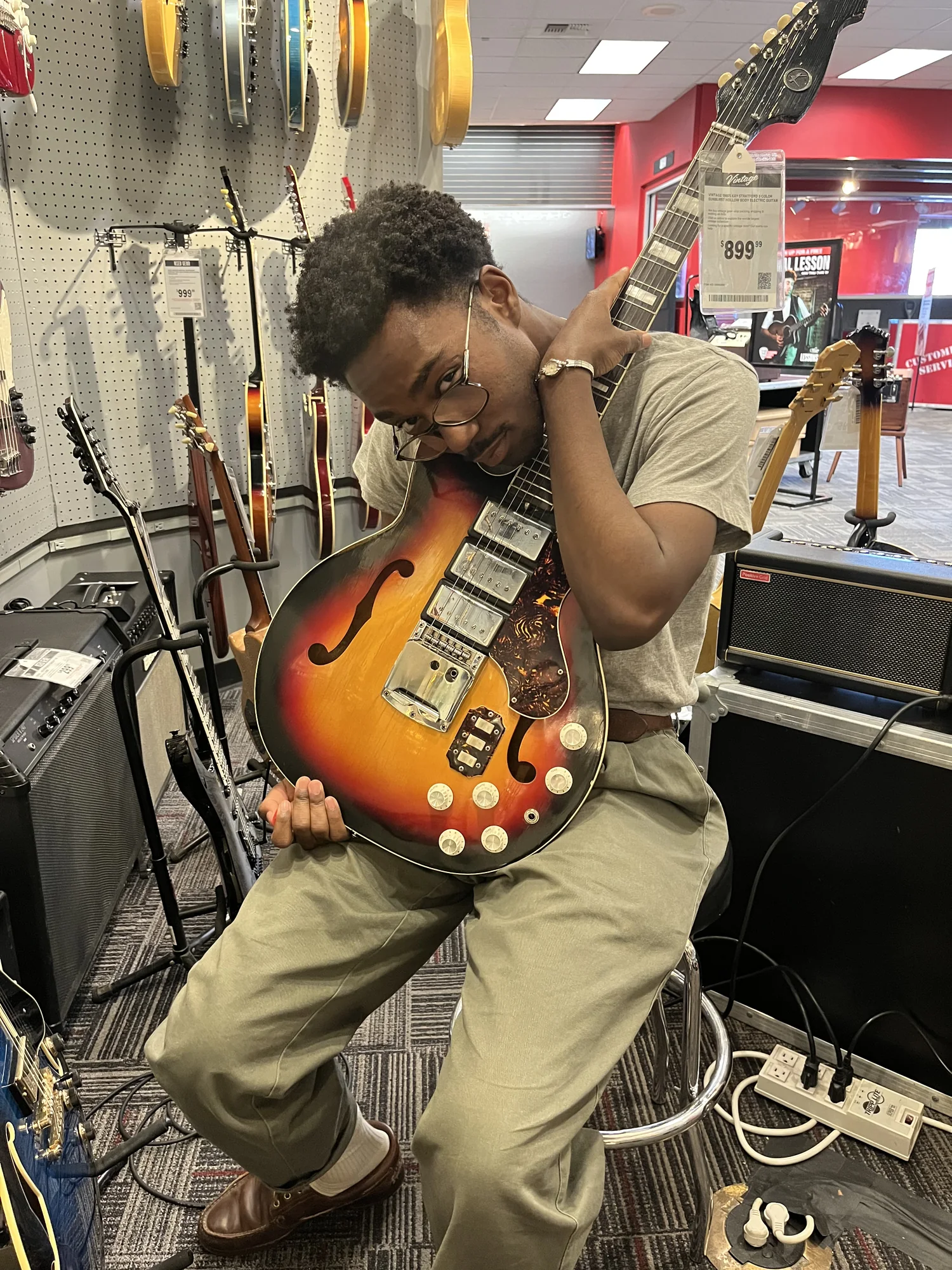 Apostle holding a guitar in a music store